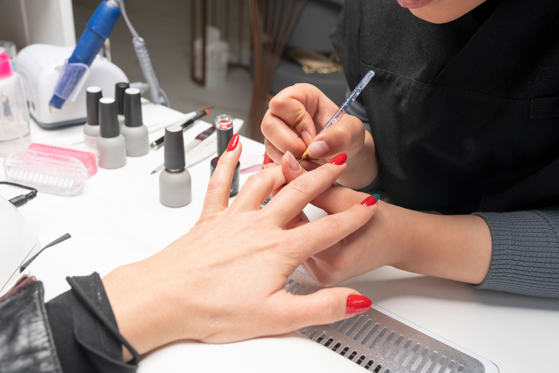 The manicurist is making new nails. Manicure. Beauty treatment and hand care